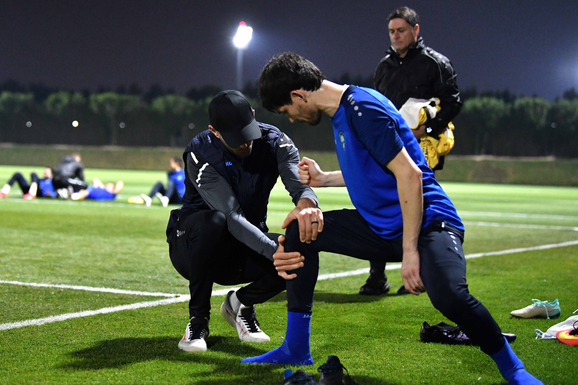 Ian coaching an athlete on the pitch